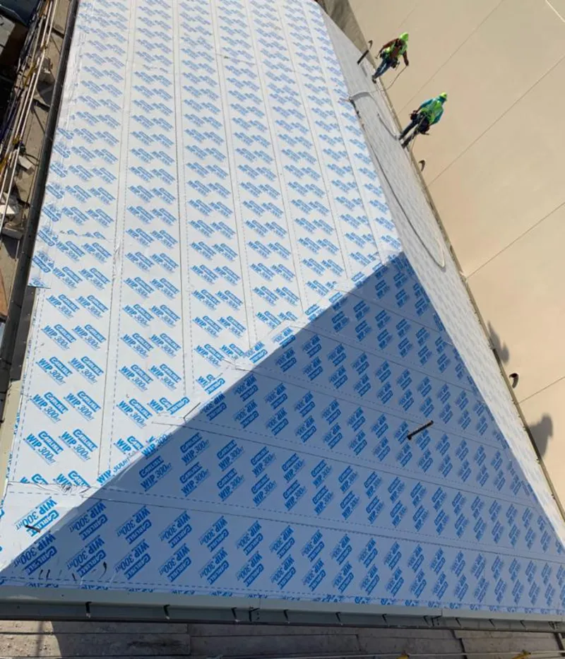 Professional roofers installing underlayment on a metal roof in Lexington